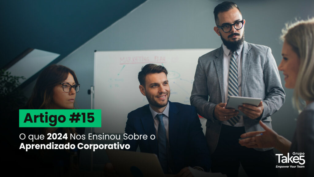 Grupo de profissionais reunidos em reunião corporativa, conversando e analisando informações com apoio de tablet e quadro ao fundo. À esquerda, texto em destaque: “Artigo #15 – O que 2024 Nos Ensinou Sobre o Aprendizado Corporativo”. A cena representa troca de conhecimento, aprendizado organizacional, colaboração e desenvolvimento profissional. No canto inferior direito, identidade visual do Grupo Take5.